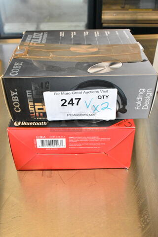 2 Items Including Coby Aluminum Foldz Headphones and Coby Stereo Bluetooth Headphones. 2 Times Your Bid! 