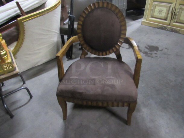 One OverSIzed Wooden Chair With A Brown Cushioned Seat And Back. 