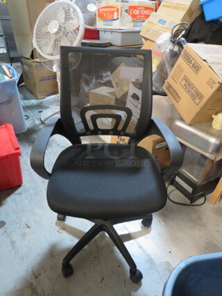 One Office Chair With Cushioned Seat And Mesh Back On Casters.