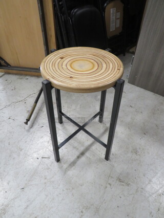 One Black Metal Bar Height Stool With A Wooden Seat. 