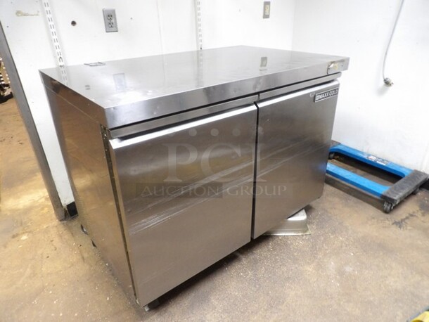 Maxx Cold, 2-Door Freezer Stainless Prep Table W/Moderate Wear. TESTED AND WORKING. 

Small Sections of Plastic on Inside of Doors Cracked/Missing and Dents/Scuffs to Inner Compartment. Missing One Castor and One Other Needs Reattached or Repaired. 

48.5"x30.25"x37.5"
