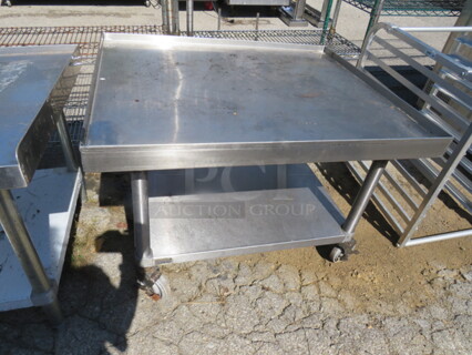 One Stainless Steel Equipment Table With SS Under Shelf On Casters. 36X30X25