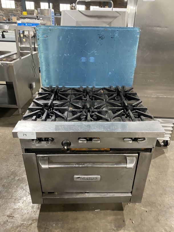 Garland Commercial Natural Gas Powered 6 Burner Stove! With Raised Back Splash! With Oven Underneath! Metal Oven Rack! All Stainless Steel! On Casters!