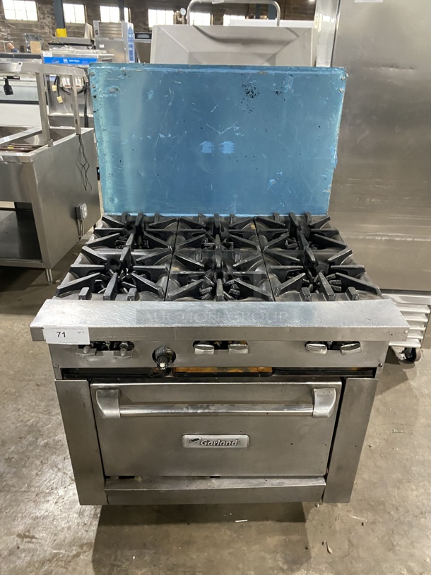 Garland Commercial Natural Gas Powered 6 Burner Stove! With Raised Back Splash! With Oven Underneath! Metal Oven Rack! All Stainless Steel! On Casters! - Item #1127750