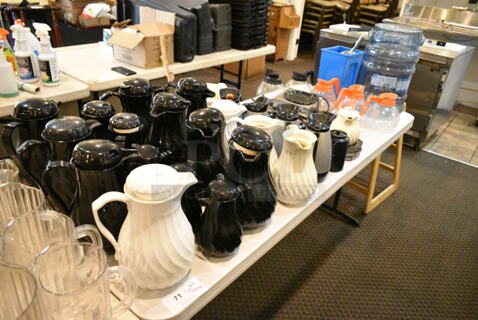 Dining Height Folding Table w/ Contents Including Poly Coffee Carafes and Coffee Pots. (main dining room)