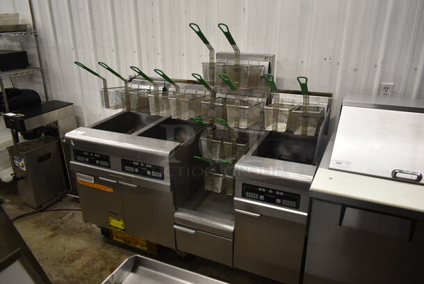 2014 Frymaster FMPH355SC Stainless Steel Commercial Floor Style 3 Bay Deep Fat Fryer w/ Fry Basket Hanging Station and 14 Metal Fry Baskets on Commercial Casters. 80,000 BTU. Unit Was Working When Removed.