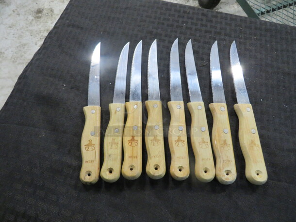 One Lot Of 8 Wooden Handle Steak Knives.