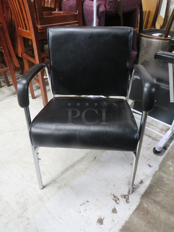 One Black Cushioned Reclining Shampoo Chair.