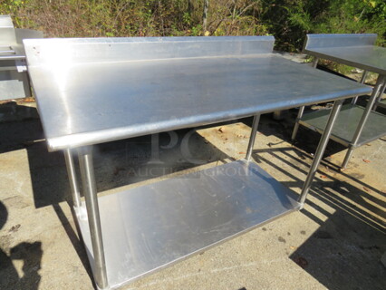 One Stainless Steel Table With Back Splash And SS Under Shelf. 60X30X40.5