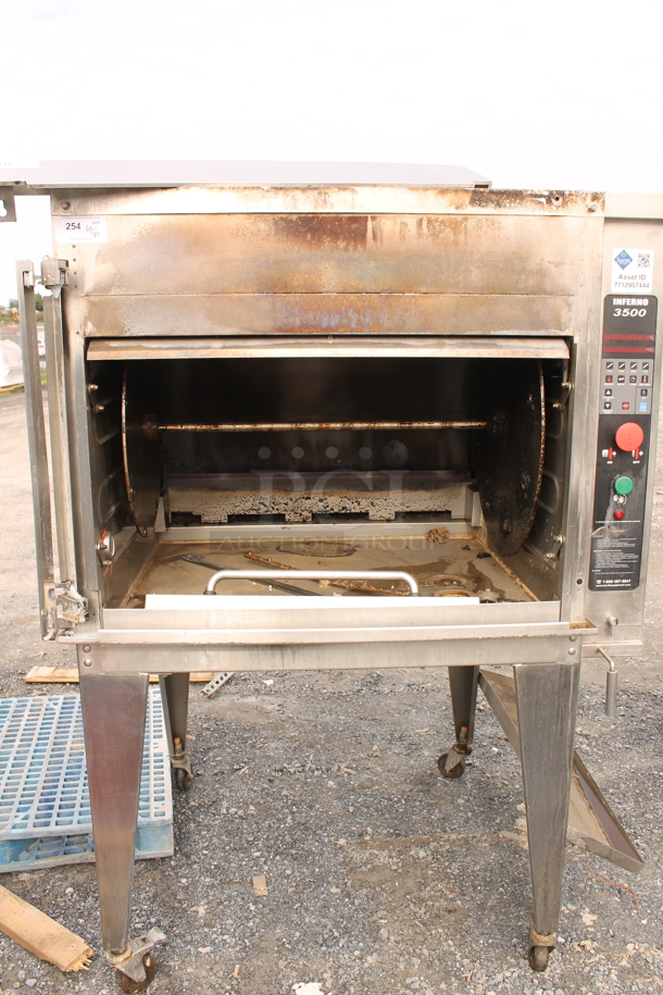 Hardt Inferno 3500 Stainless Steel Commercial Floor Style Natural Gas Powered Rotisserie Oven w/ Metal Legs on Commercial Casters. Missing Glass Door.
