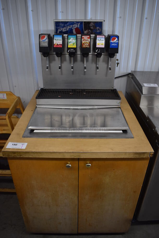 Stainless Steel Commercial 6 Flavor Carbonated Beverage Machine w/ Drop In Ice Bin on Wood Pattern Counter. 30.5x34x59