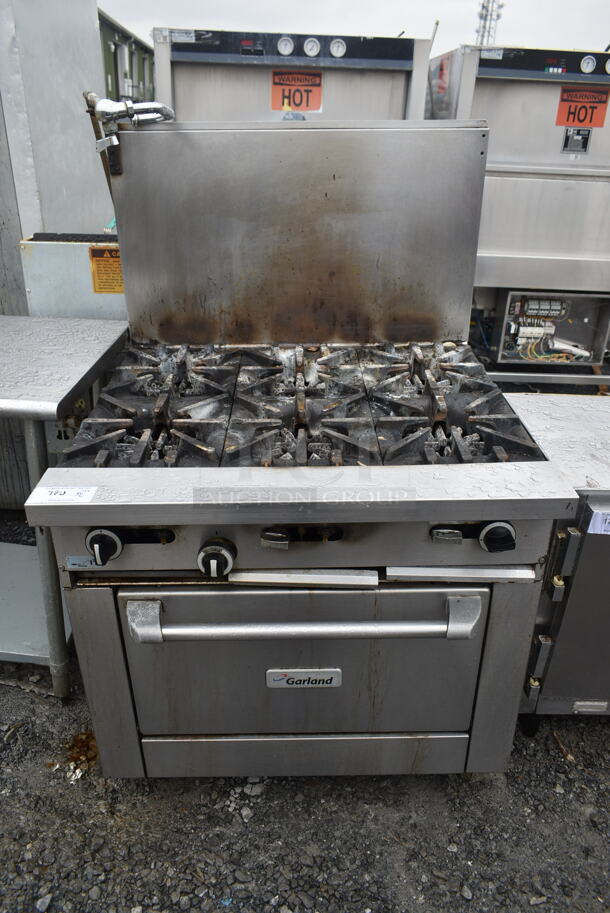 Garland G36-6R Stainless Steel Commercial Natural Gas Powered 6 Burner Range w/ Oven and Back Splash. 