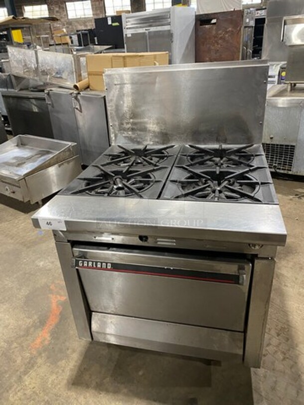 Garland Commercial Natural Gas Powered WIDE BODY 4 Burner Stove! With Oven Underneath! All Stainless Steel! With Raised Back Splash! GREAT FOR BIG POTS! On Legs!