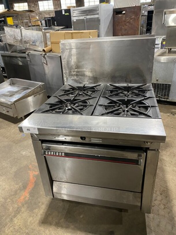 Garland Commercial Natural Gas Powered 6 Burner Stove! W/ Oven Underneath! Stainless Steel W/ Back Splash And Salamander Shelf! On Legs! - Item #1127399