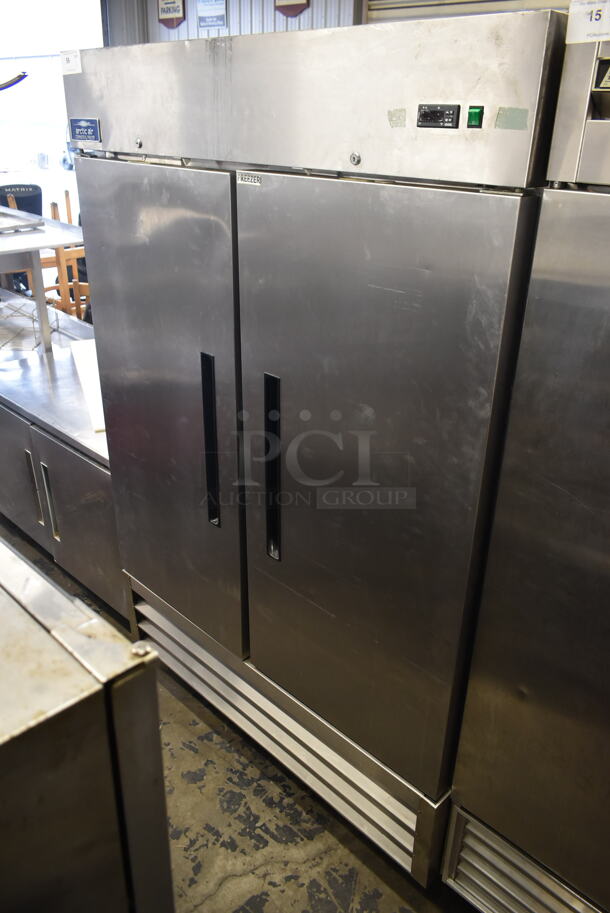 Arctic Air AF49 Stainless Steel Commercial Double Door Reach In Freezer w/ Poly Coated Racks on Commercial Casters. 115 Volts, 1 Phase. Tested and Working!