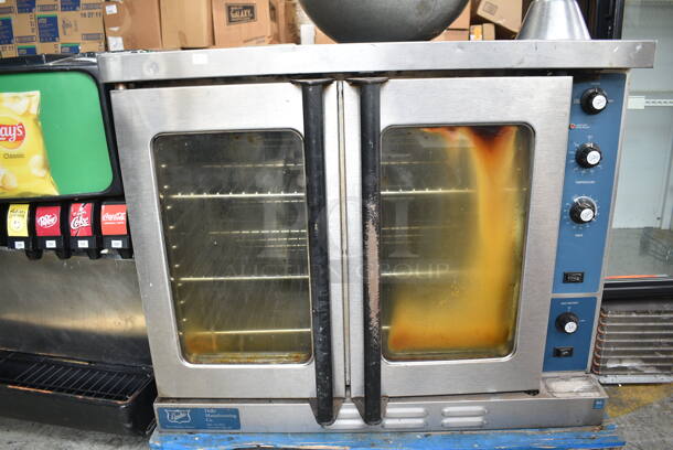 Duke Stainless Steel Commercial Natural Gas Powered Full Size Convection Oven w/ View Through Doors, Metal Oven Racks and Thermostatic Controls. 