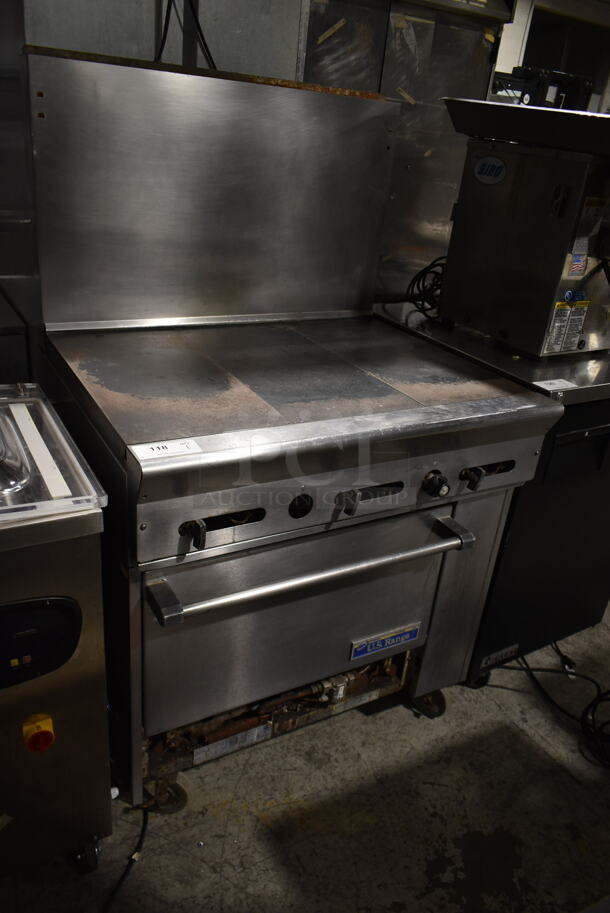 US Range PX-3HT-26 Stainless Steel Commercial Natural Gas Powered Flat Top Griddle w/ Oven and Back Splash on Commercial Casters. 