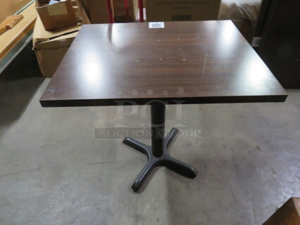 One Brown Laminate Table Top On A Pedestal Base. 30X24X29