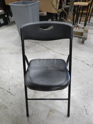 Black Poly Folding Chair With A Black Cushioned Seat. 5XBID